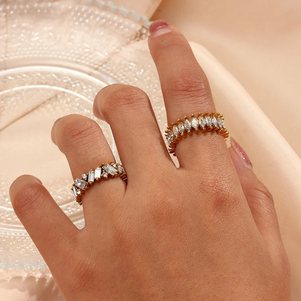 "Close-up of a gold ring with a jagged baguette cut design of cubic zirconia stones, exuding elegance and edgy sophistication."