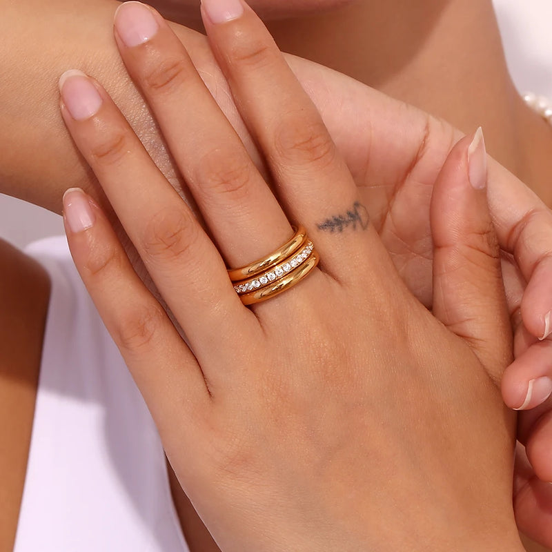 "Close-up of a 3-piece ring set, one band adorned with paved cubic zirconia stones, offering versatility and elegance in accessory styling."