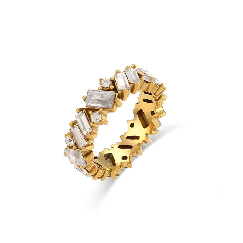 "Close-up of a gold ring with a jagged baguette cut design of cubic zirconia stones, exuding elegance and edgy sophistication."