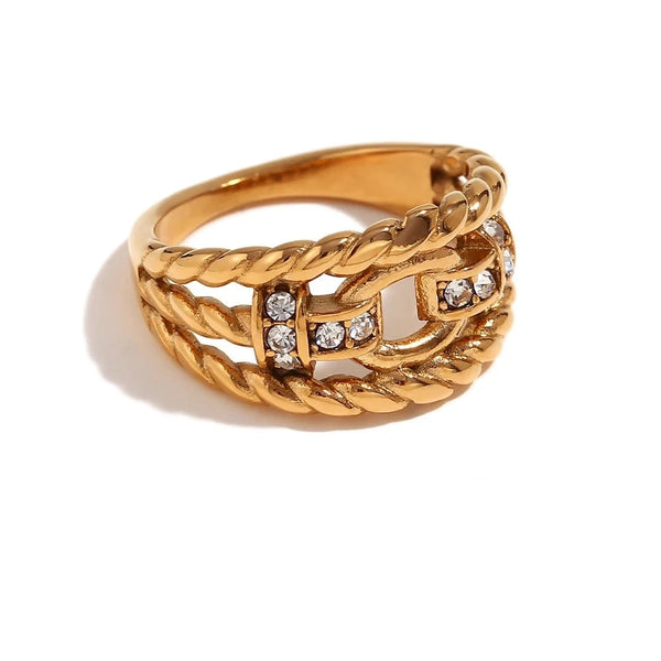 "Close-up of a twisted buckle ring adorned with cubic zirconia accents, blending edgy style with glamorous sophistication."