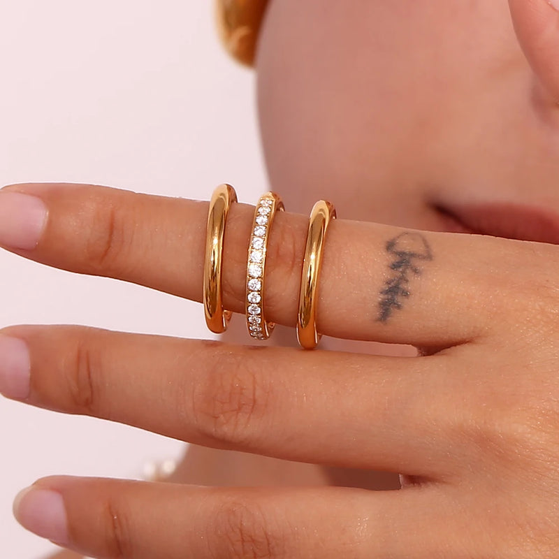 "Close-up of a 3-piece ring set, one band adorned with paved cubic zirconia stones, offering versatility and elegance in accessory styling."