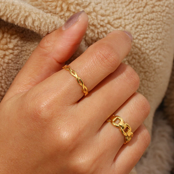 "Close-up of a ring with a thin braided band, showcasing intricate detailing and elegant simplicity."