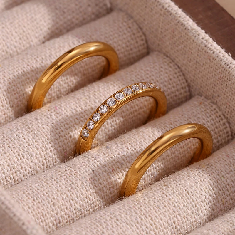 "Close-up of a 3-piece ring set, one band adorned with paved cubic zirconia stones, offering versatility and elegance in accessory styling."